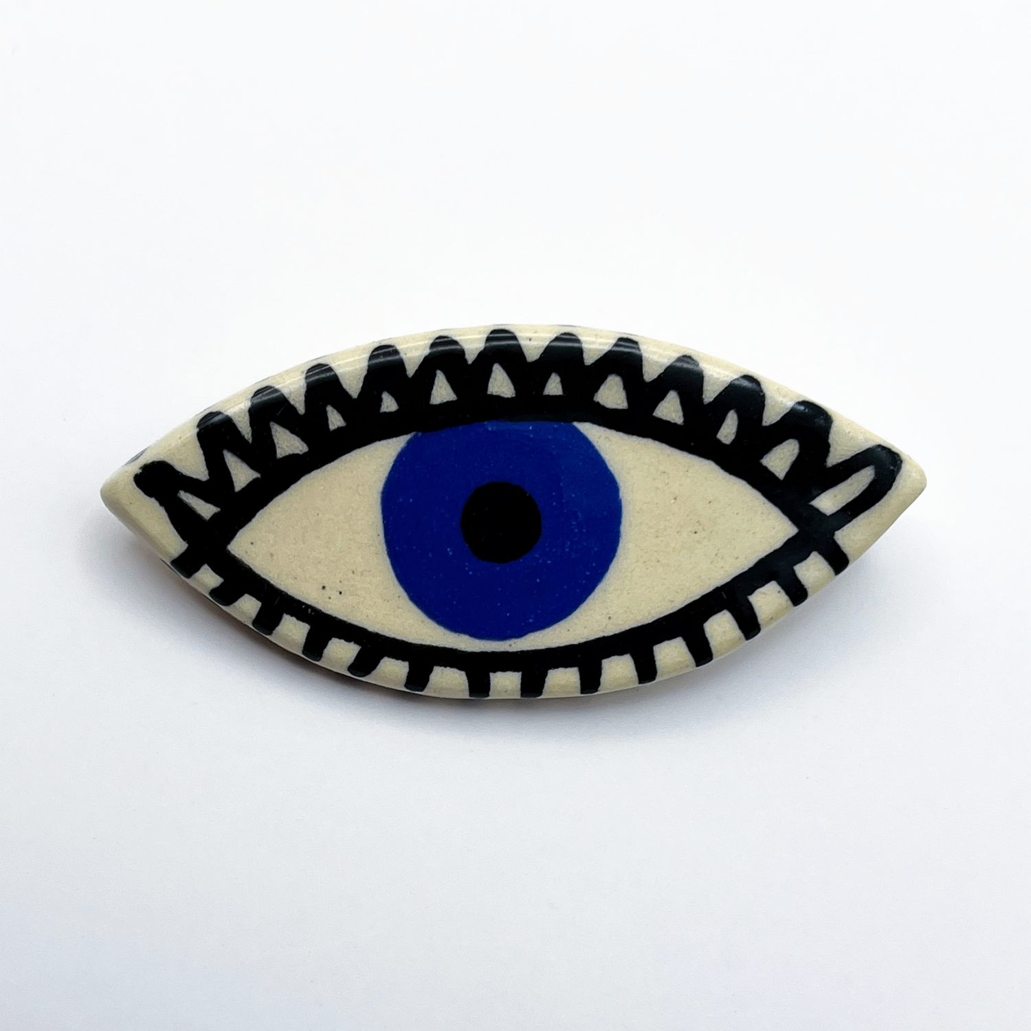 Here and Here: Blue Eye Brooch with Zigzag Lashes Product Image 1 of 2