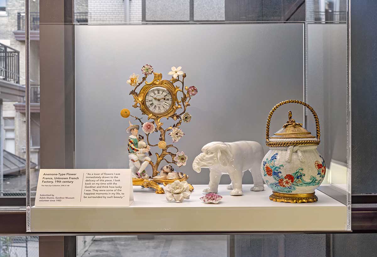 A glass vitrine with a collection of assorted ceramic objects