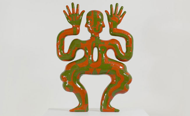 Green and red ceramic figure with wavy limbs