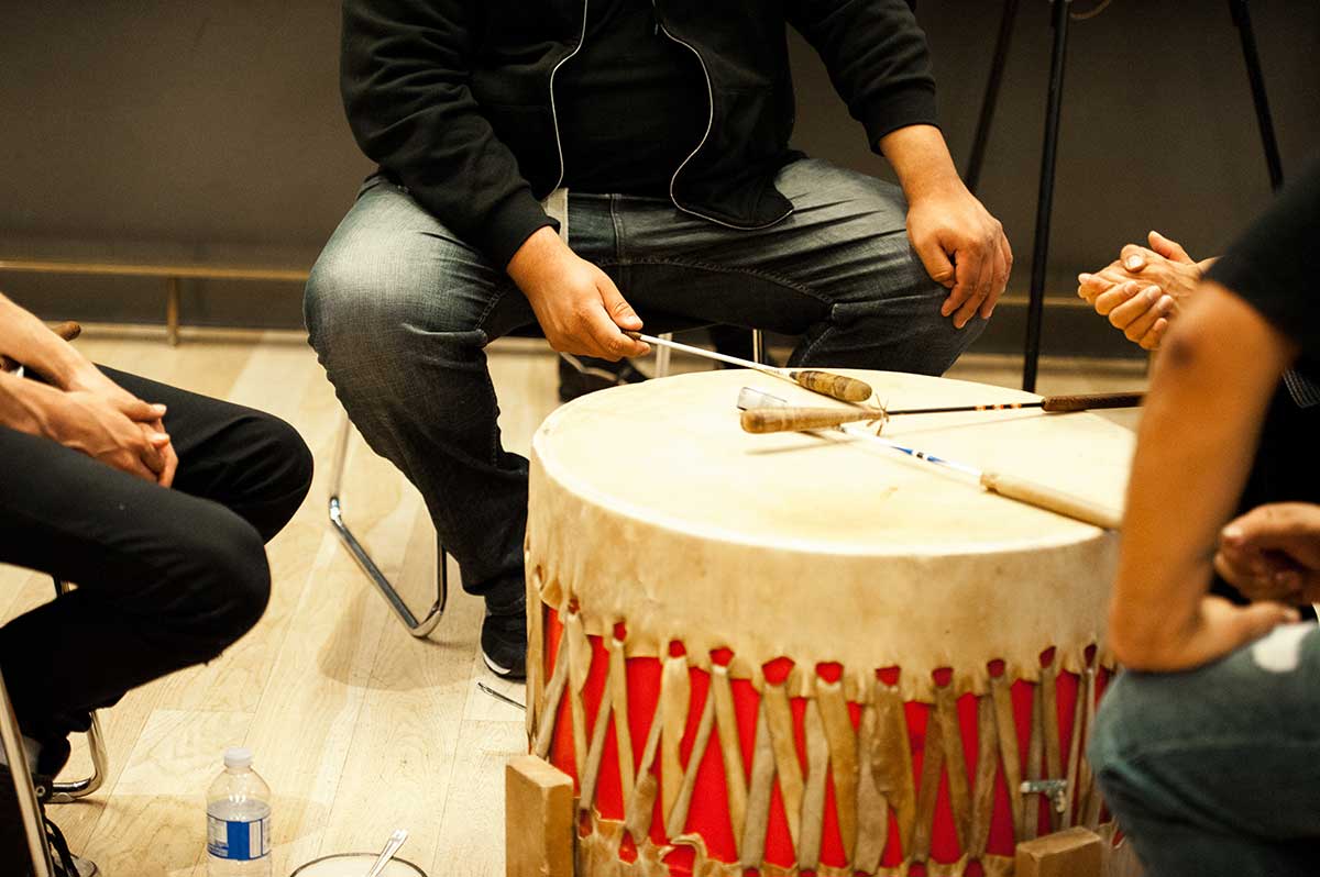 Hands of Indigenous drummers drumming