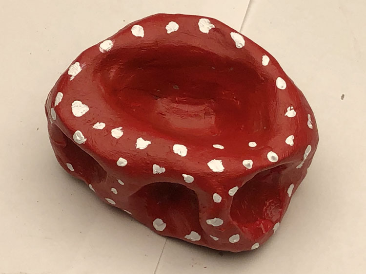 Red abstract sculpture with white dots