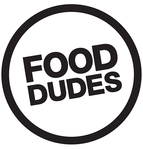 Black circle with black writing reading "Food Dudes" in the centre (Food Dudes logo)