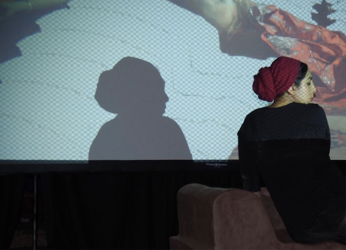 Habiba El-Sayed in silhouette in front of a screen