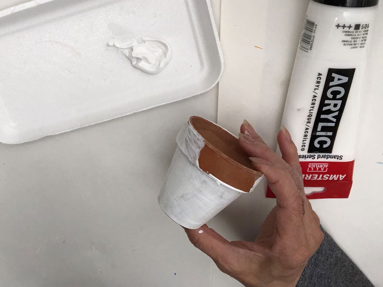 Painting a clay pot white