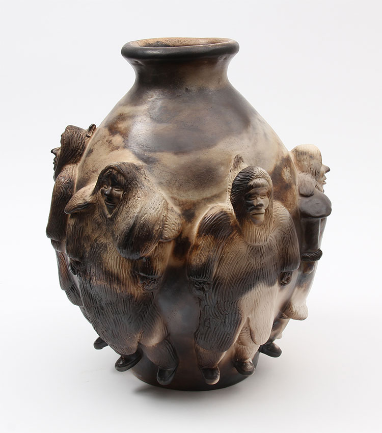 Brown vase with relief sculpture of Inuit people