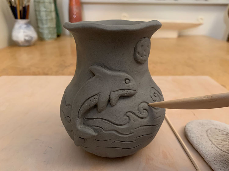 Clay pinch pot with a whale design