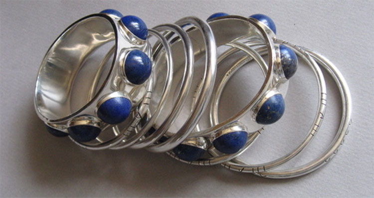 Silver bangles with blue stones