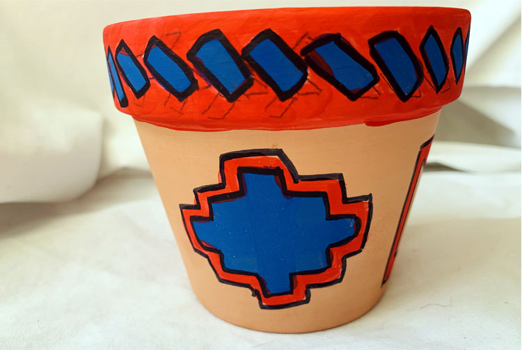 Clay pot with red and blue geometric design
