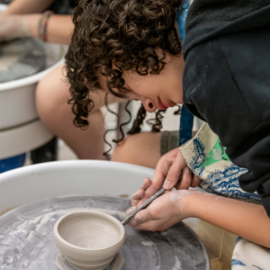 A teen using the pottery wheel