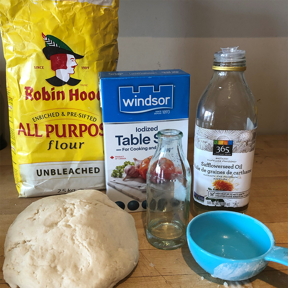 Flour, salt, vinegar, measuring cups, and dough
