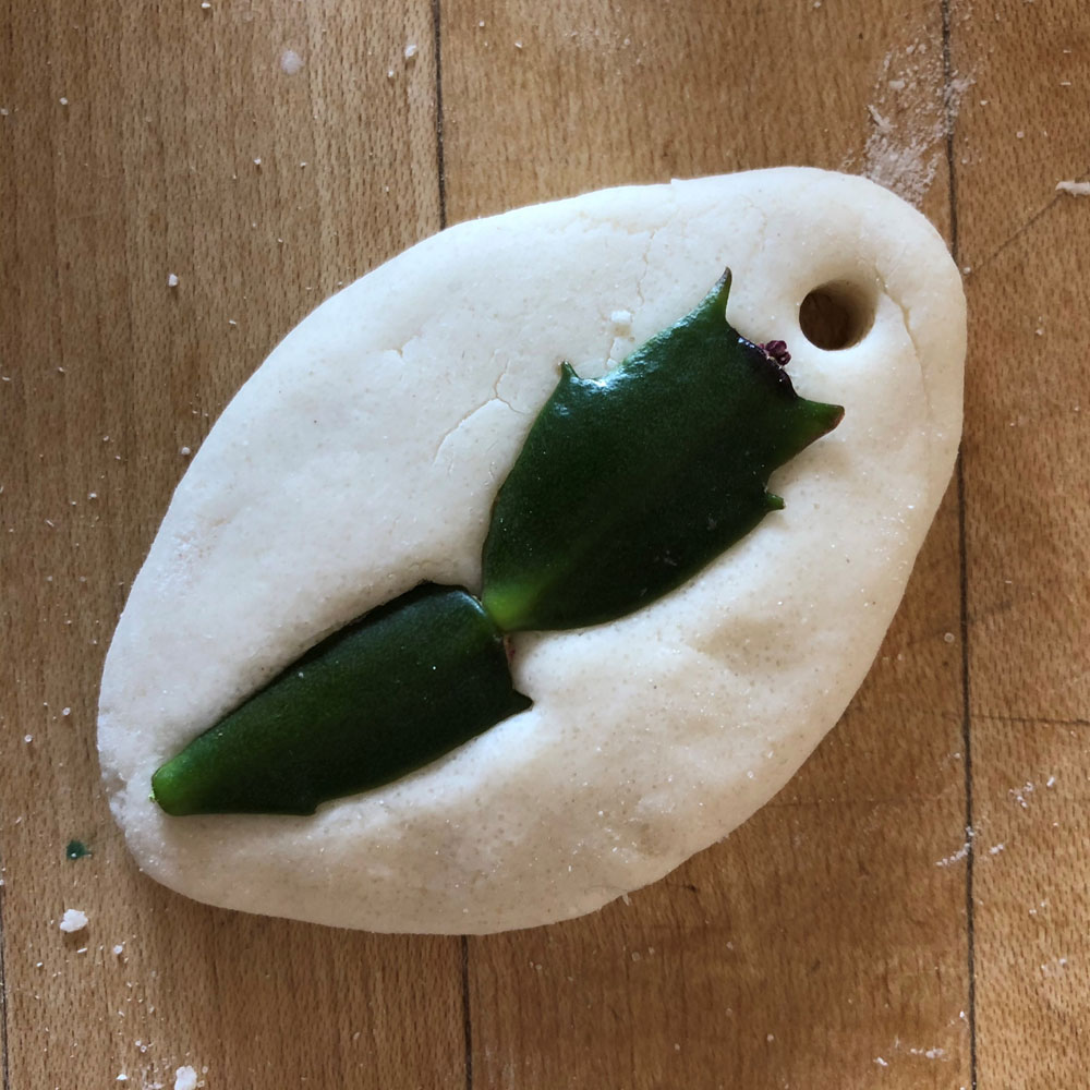 Clay dough with leaves stuck into it