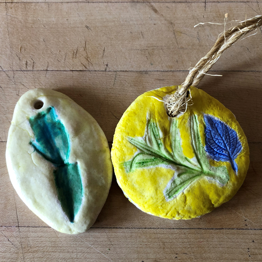 Clay medallions with painting leaf impressions