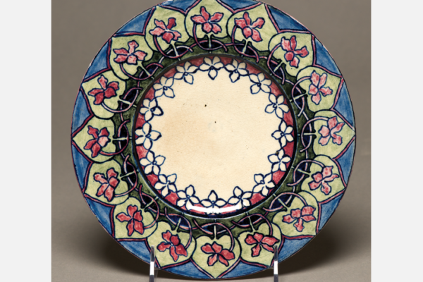 Plate, c. 1896. Underglaze painting of Southern coast violet design. Margaret H. Shelby, decorator; Jules Gabry, potter. Diameter: 8" Newcomb Art Collection, Tulane University, New Orleans, LA.