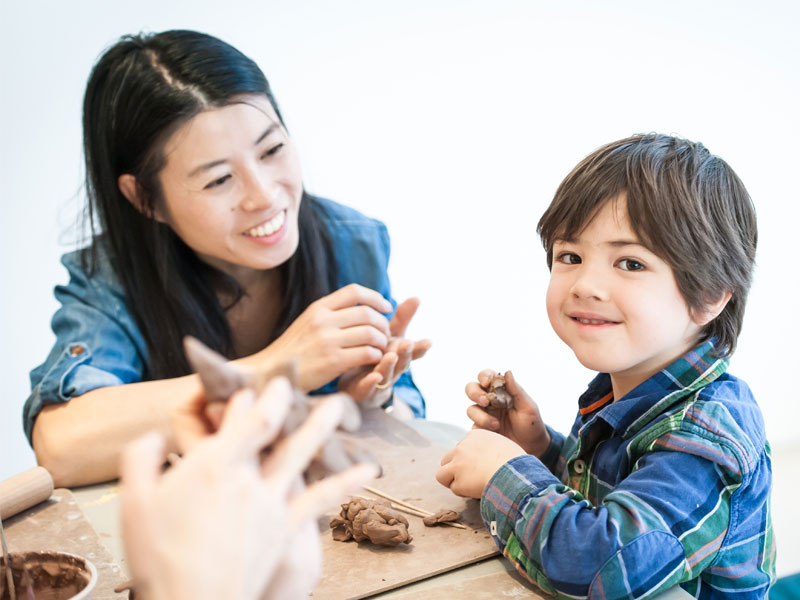 A mother and son working with clay