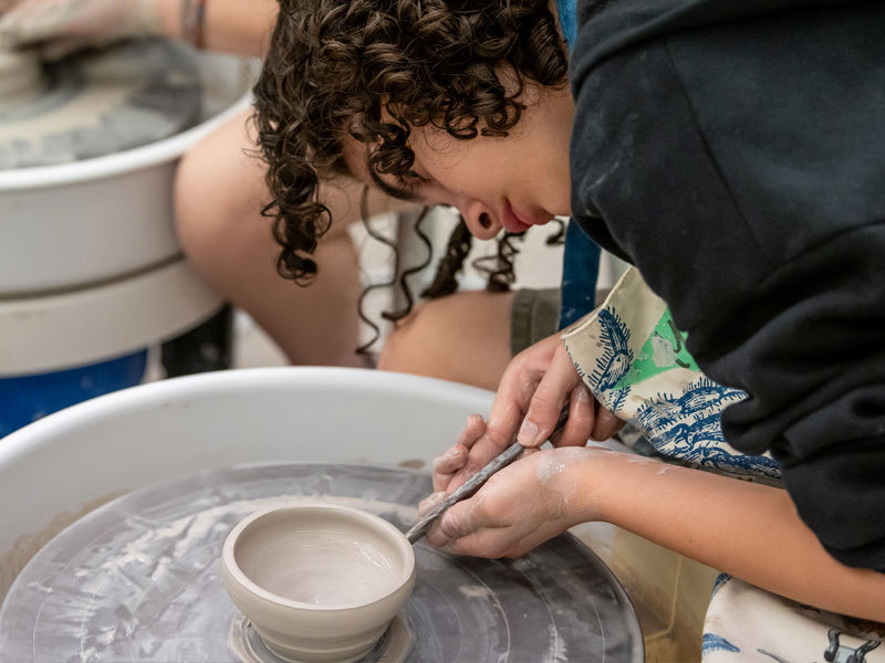 A teen using the pottery wheel