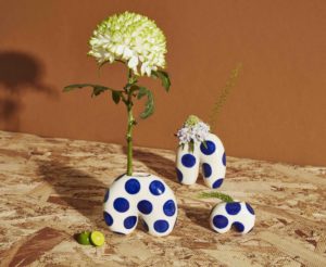 White upside-down "u" shaped ceramic planters, white with dark blue polka-dots 